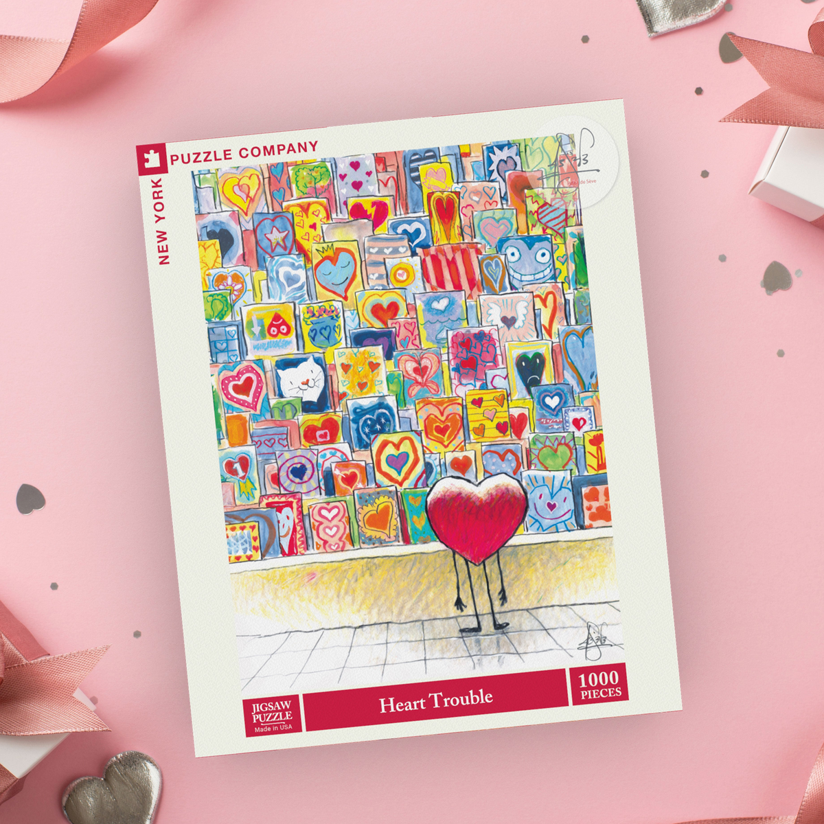 Puzzle box with colorful heart-themed design on a pink background with gift boxes and ribbons.
